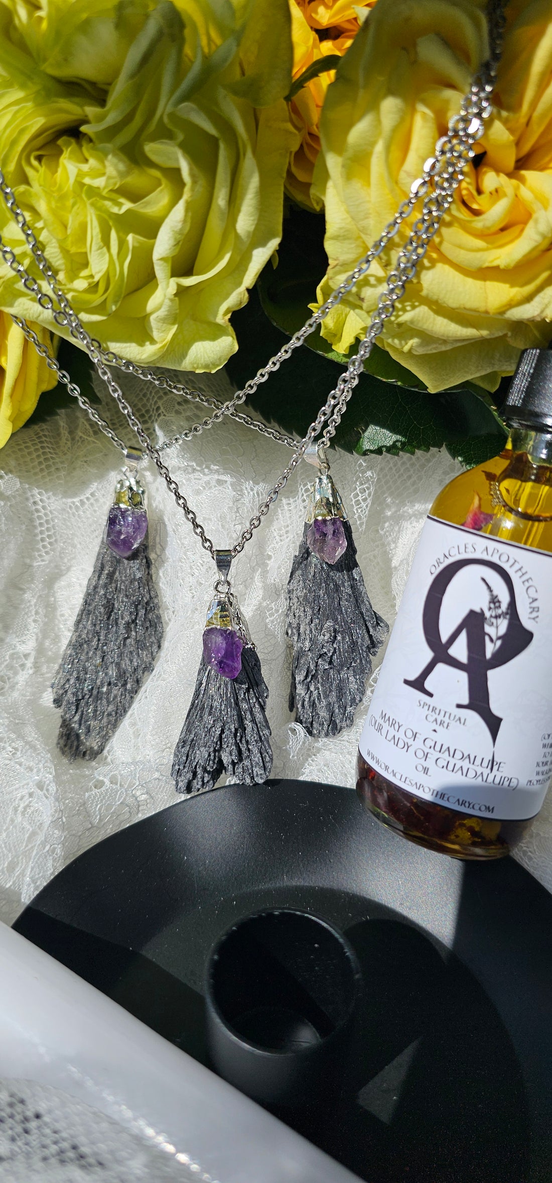Amethyst Black Kyanite Necklaces next to candle stick holder