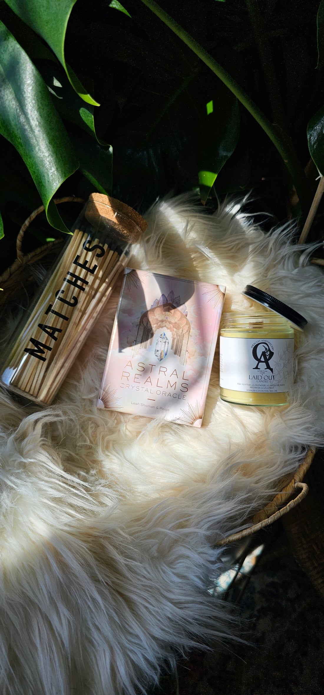 Astral Realms Crystal Oracle deck next to matches and an oracles apothecary candle
