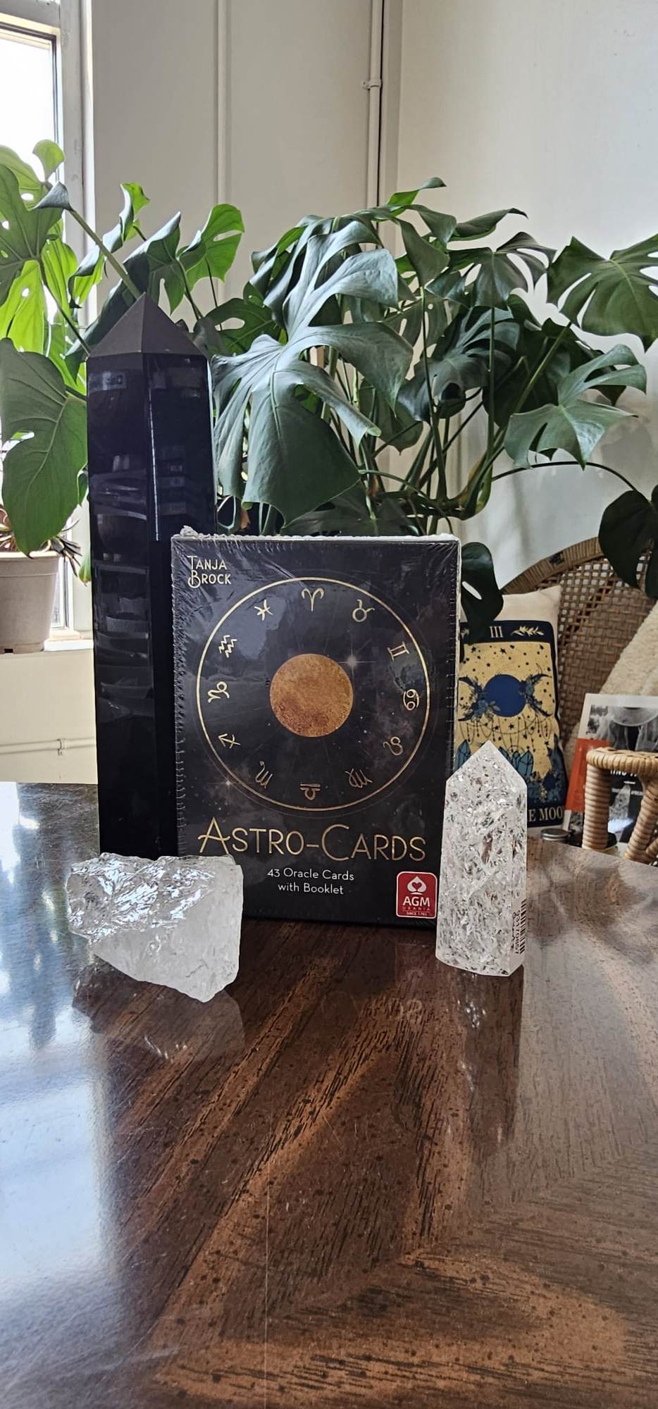Astro Cards Oracle Deck sitting on wooden table