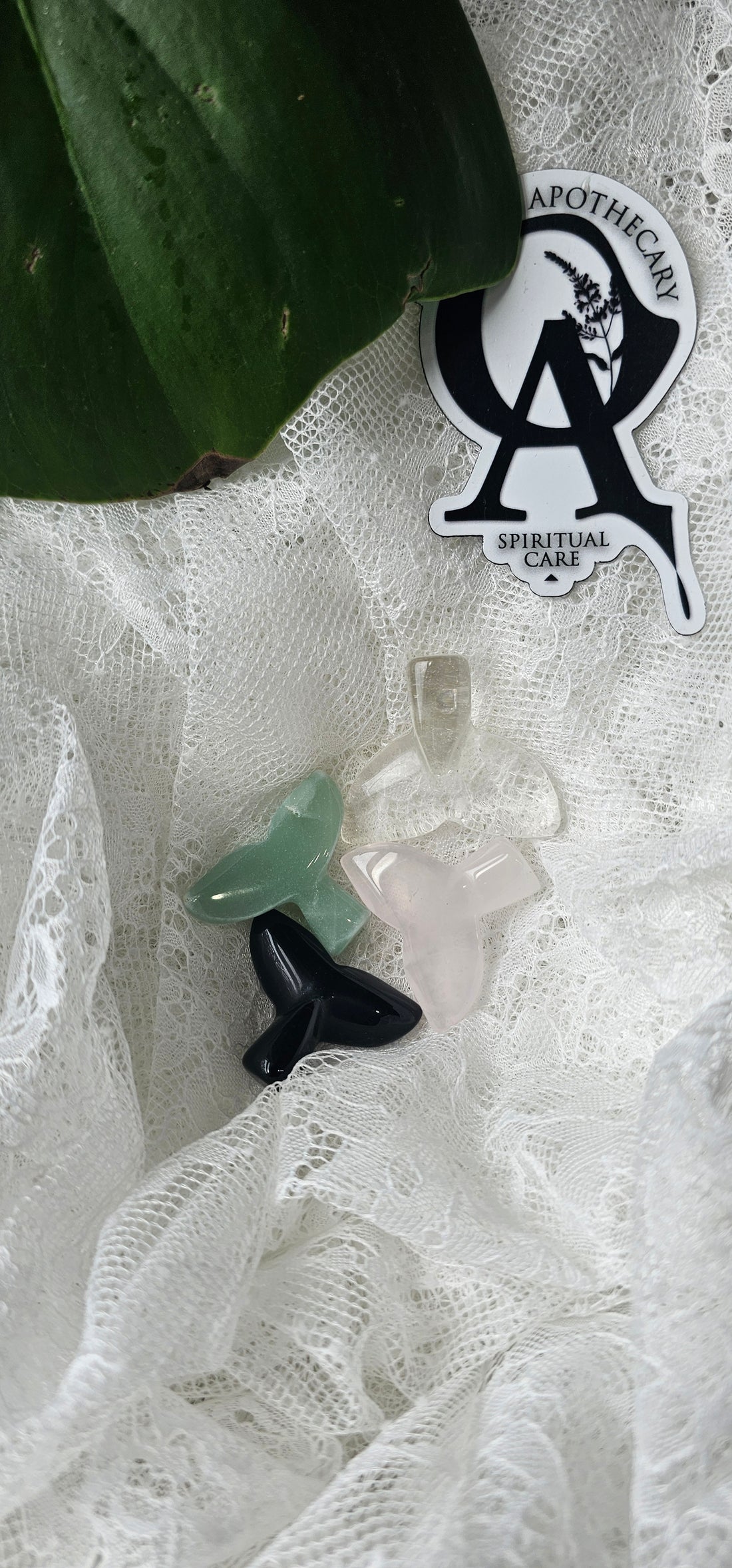 Crystal Mermaid Tails next to oracles apothecary logo