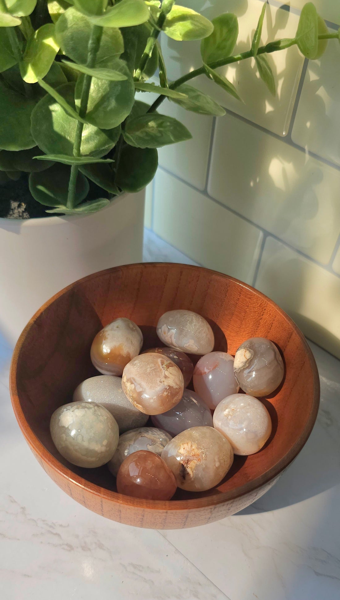 Flower Agate crystals stones in a wooden bowl