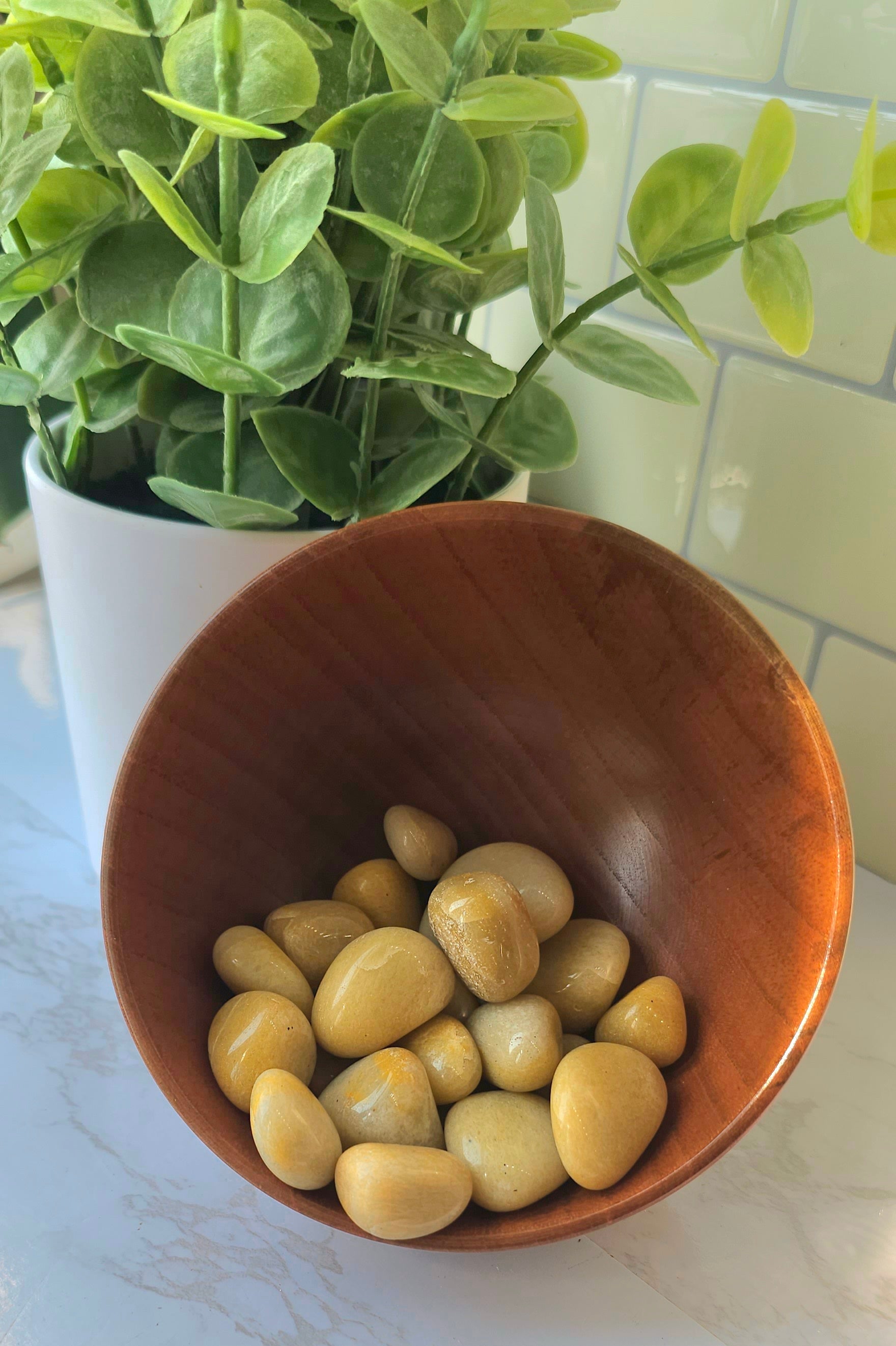 Golden-Healer Tumbled crystals stones in a wooden bowl
