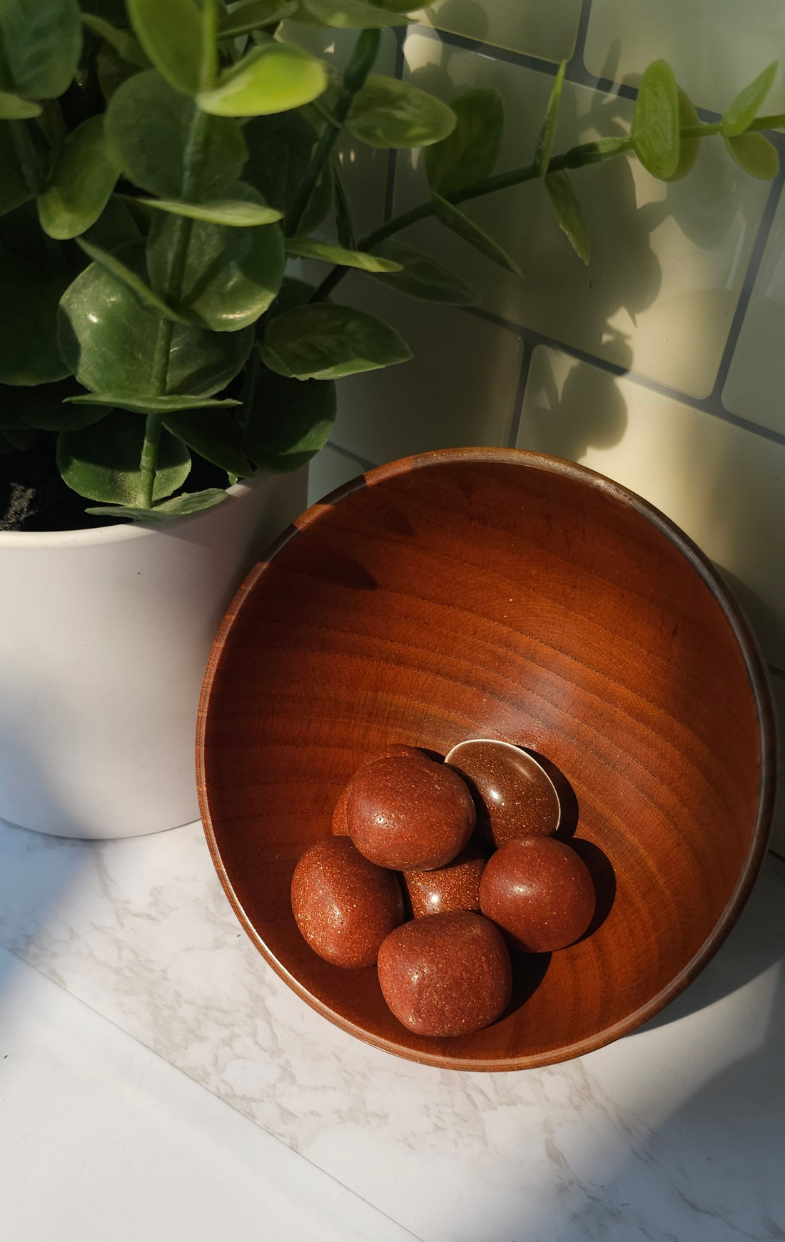 Goldstone crystals stones in a wooden bowl