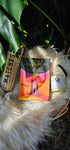 Radiant Wilds Tarot deck sitting next to matches and an oracles apothecary candle