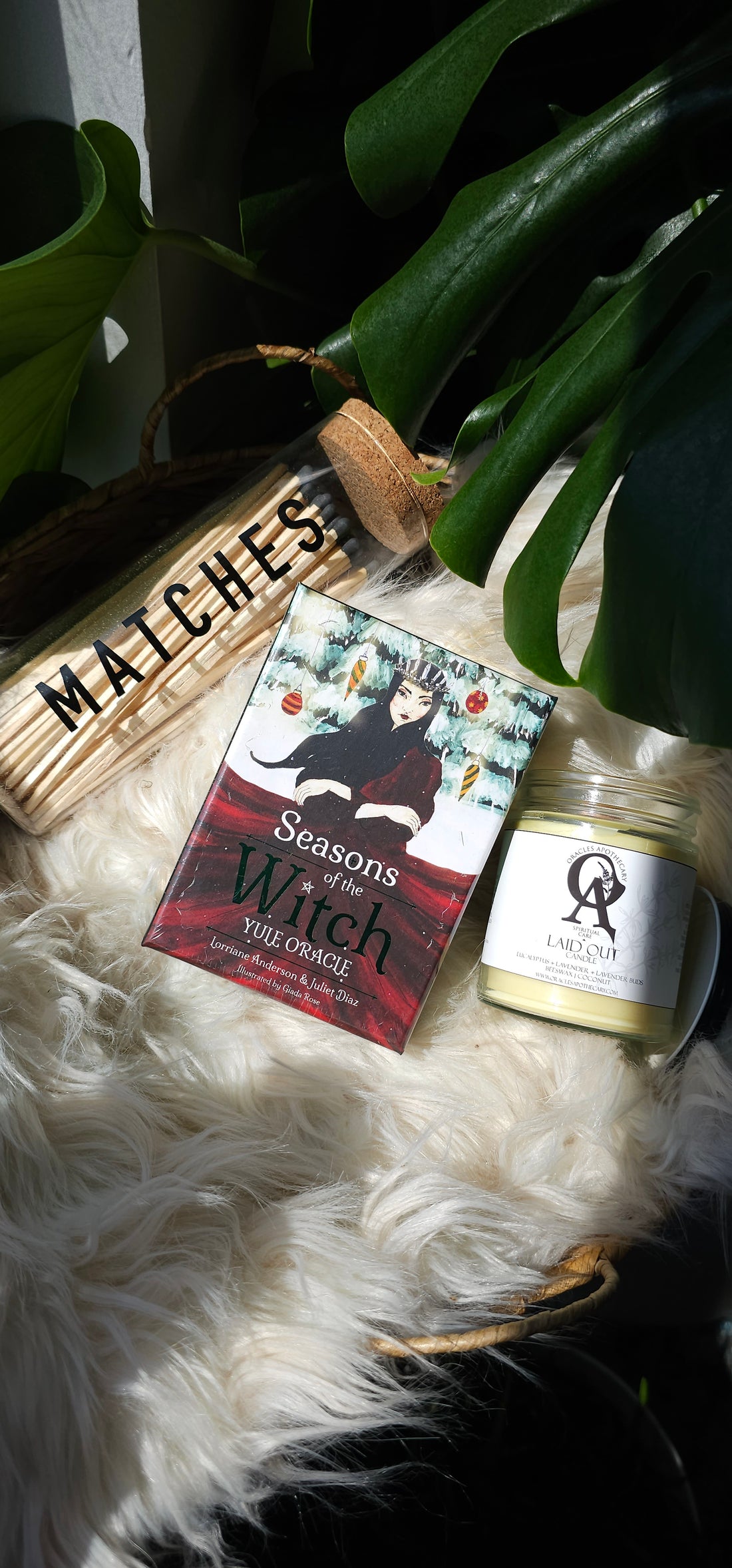Seasons of the Witch: Yule Oracle deck sitting next to matches and an oracles apothecary candle