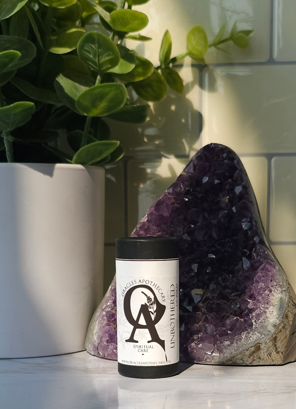 Unbothered Lip Balm (Unscented) sitting on a white counter top