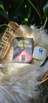 Witching Hour Oracle deck next to matches and an oracles apothecary candle