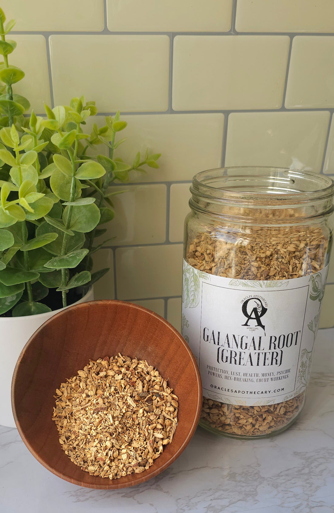 Greater Galangal Root in a wooden bowl next to a glass jar