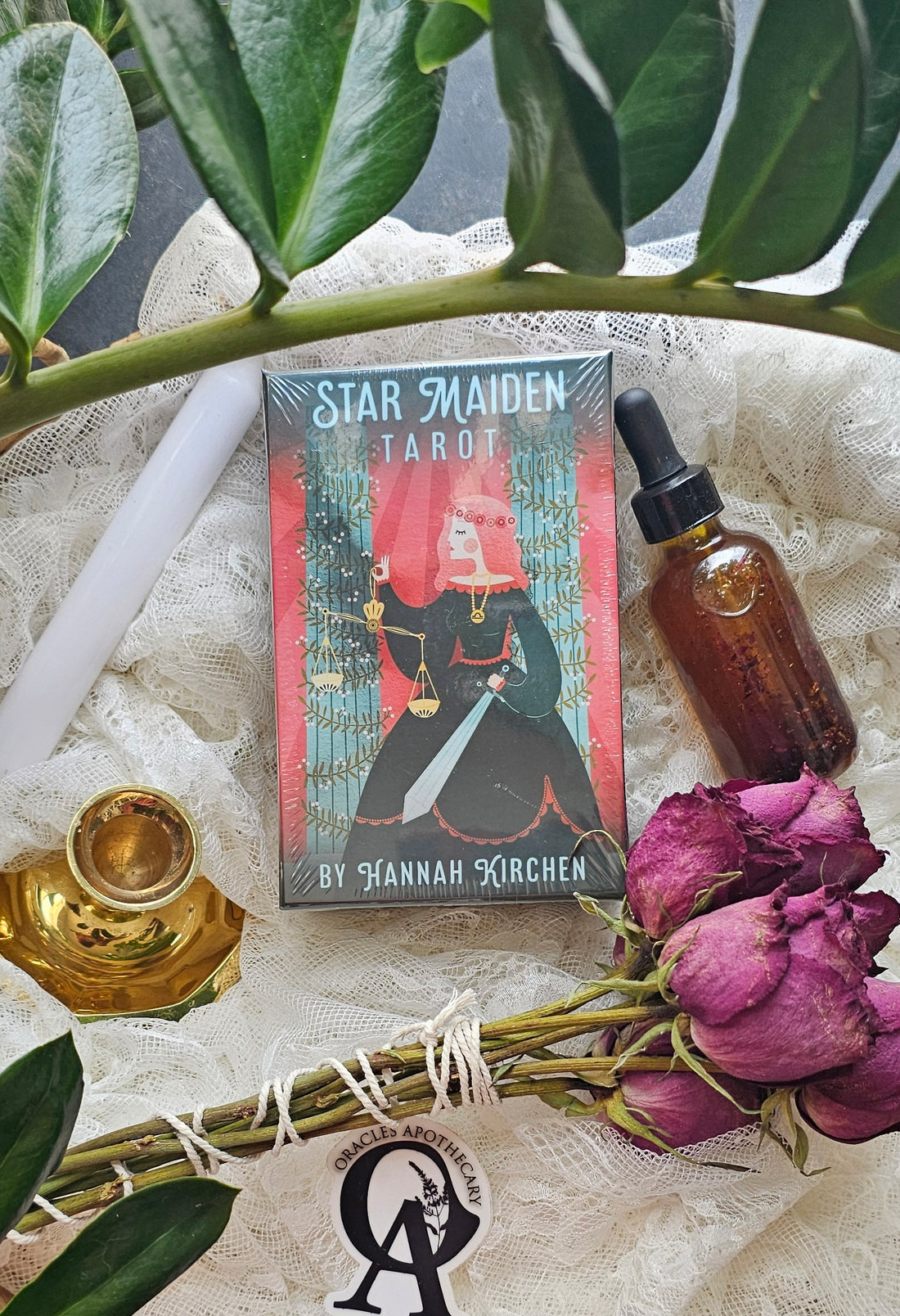 star maiden tarot deck cover next to roses and tincture