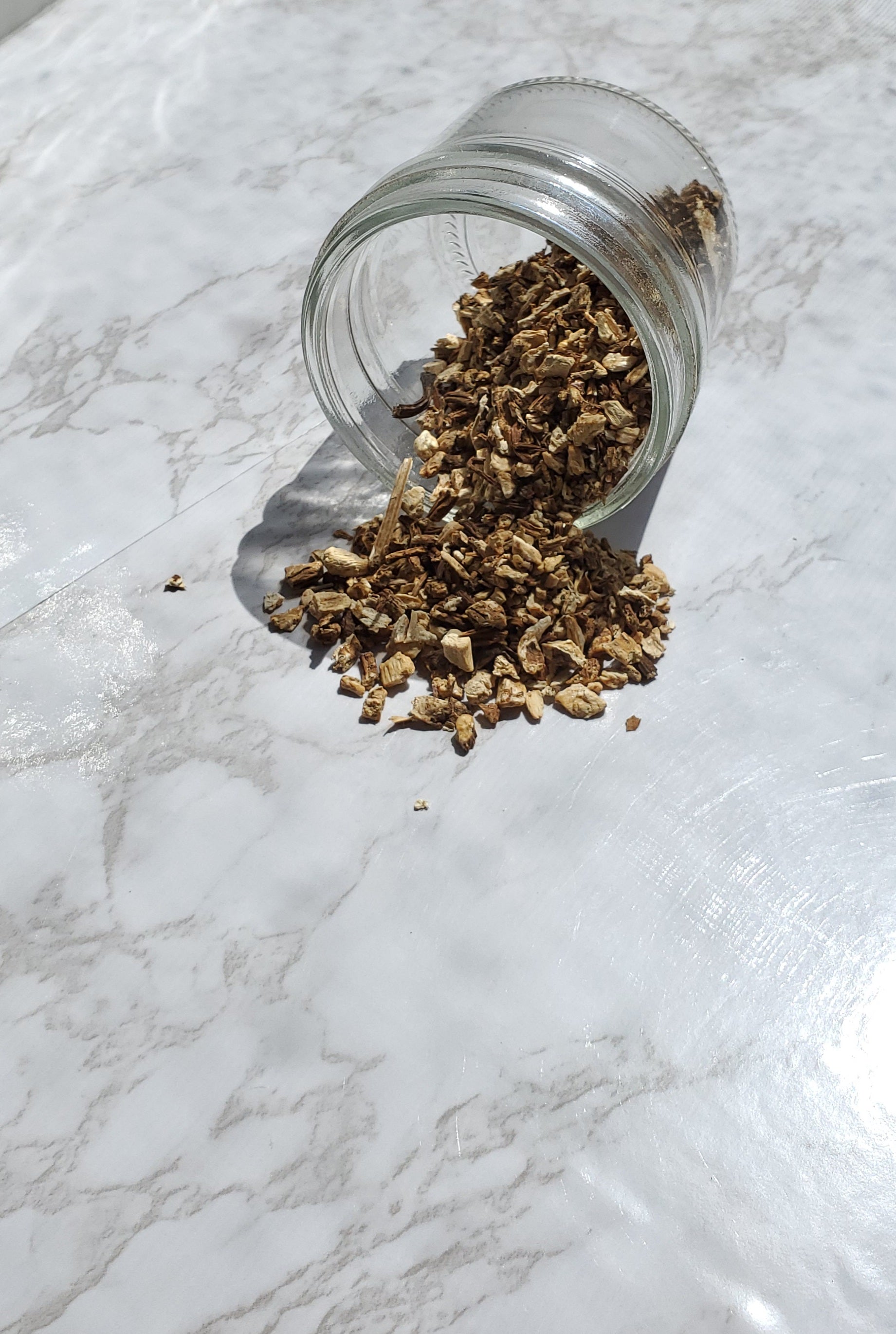 Angelica Root spilling out of a glass jar