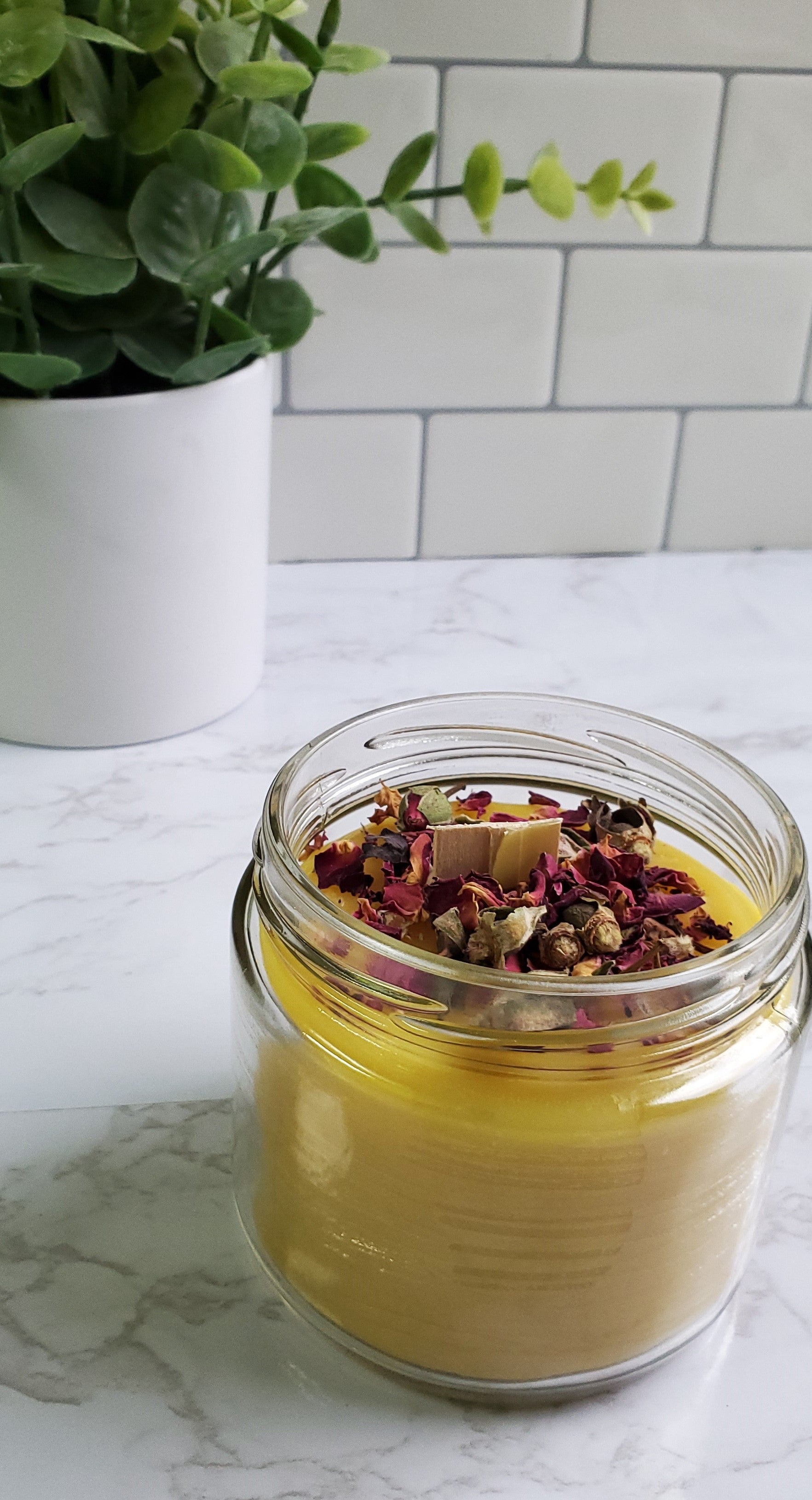 feeling myself candle with whisper wick and herbs on top inside glass jar