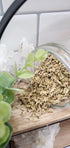 Fennel Seed spilling from a glass jar on to a shelf