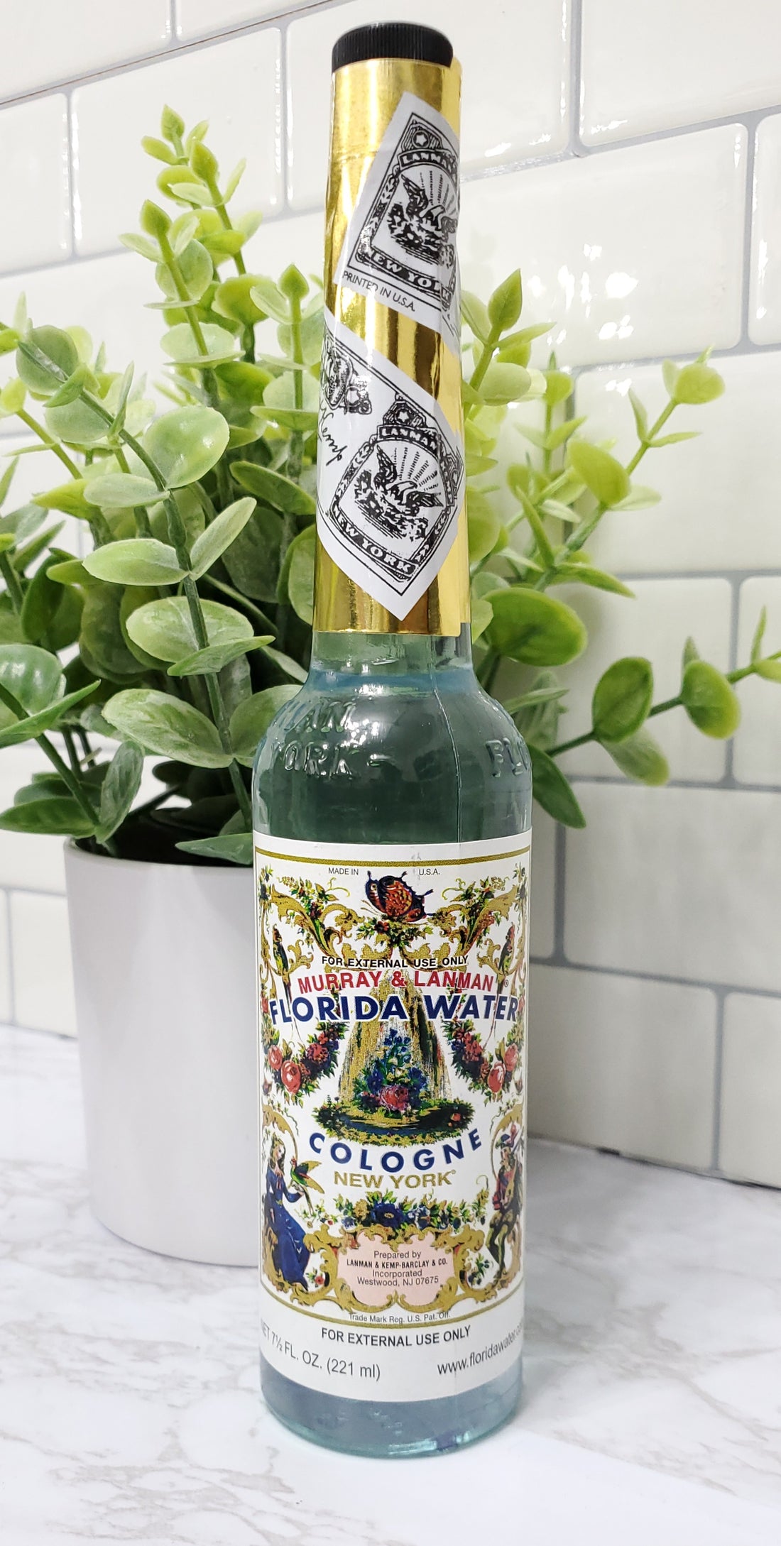 Florida Water in a glass bottle sitting on a shelf