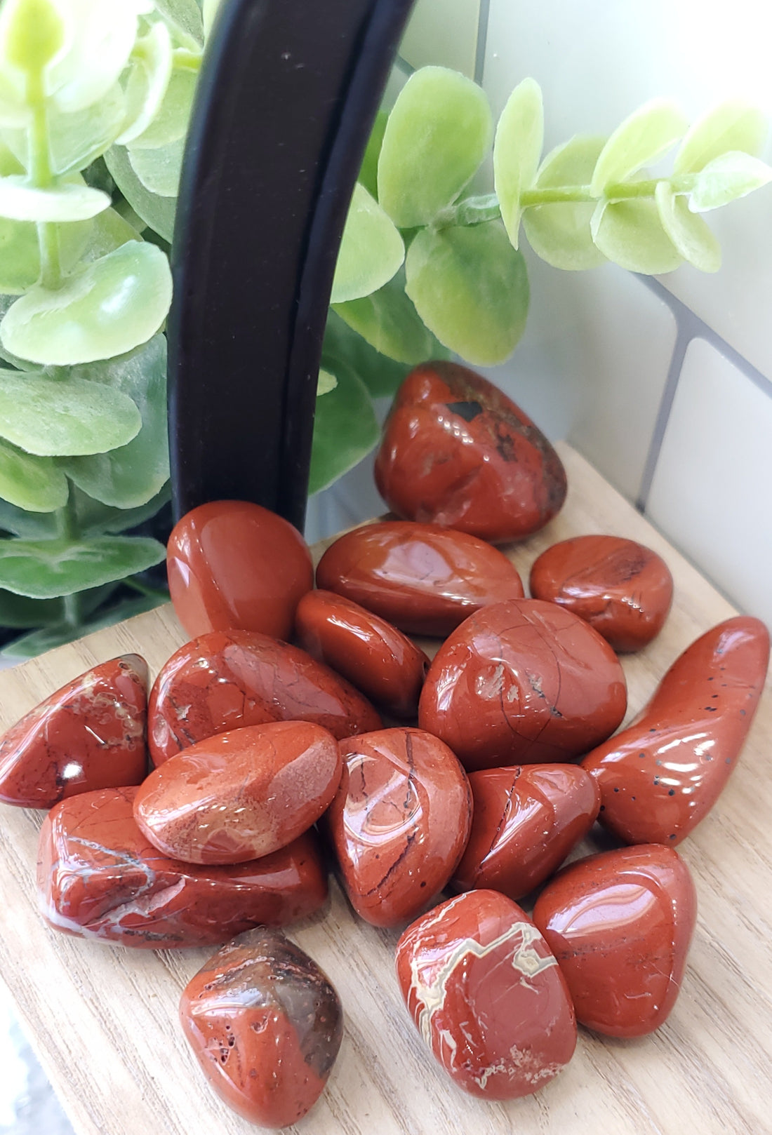 Red Jasper crystals stones piled up on wooden shelf