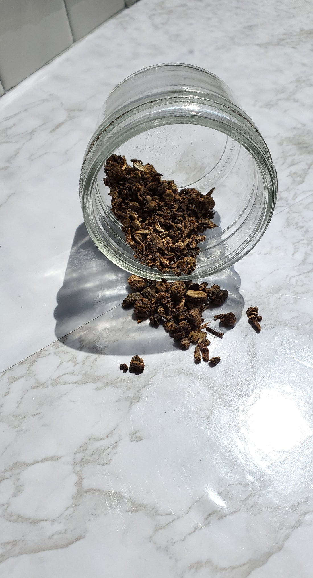 valerian root spilled out of a glass jar