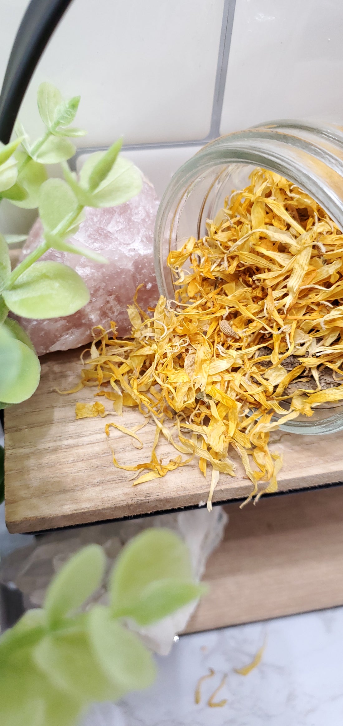Calendula spilling out of a glass jar