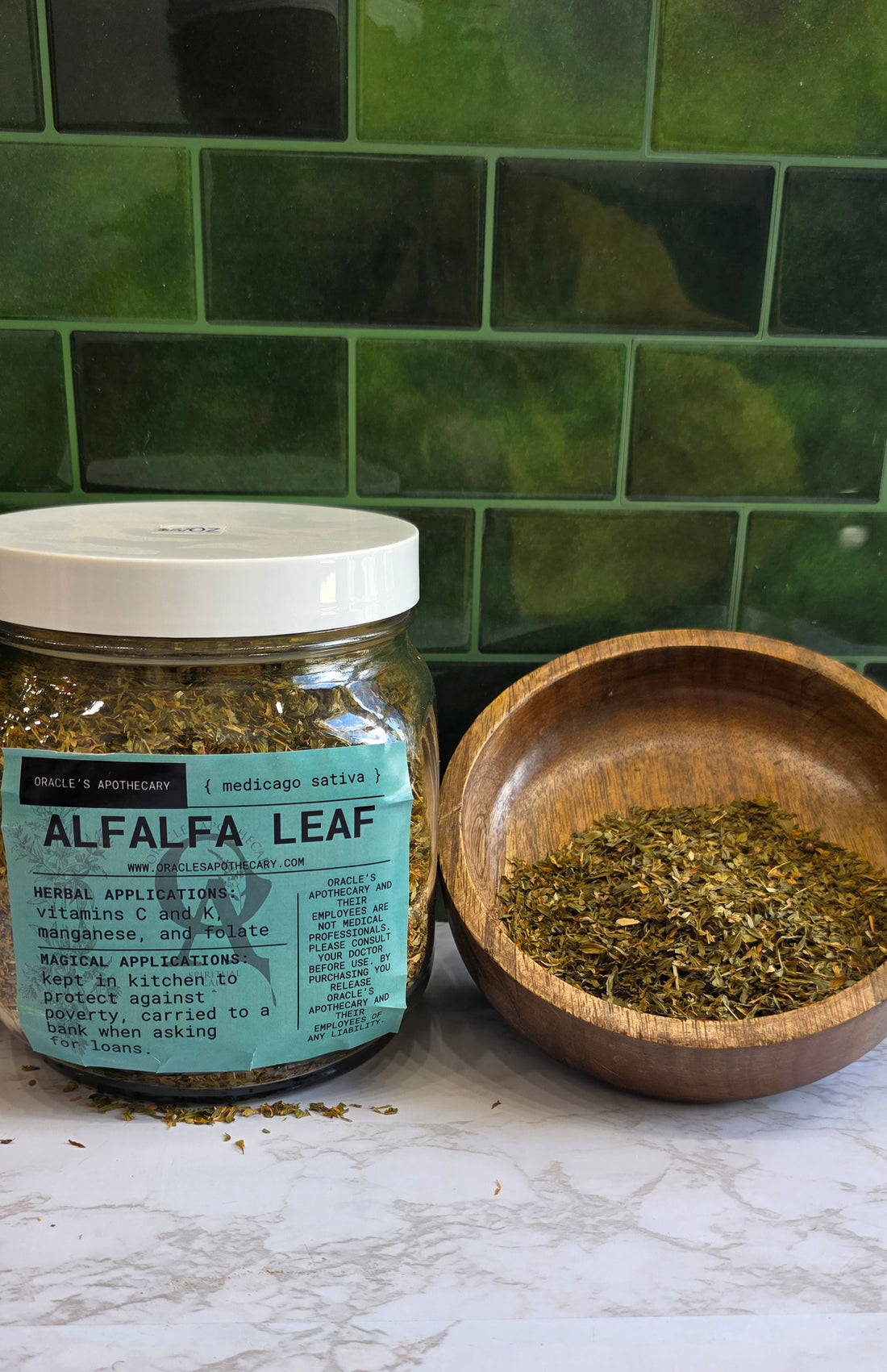Alfalfa leaf in a jar with a label and loose on a wooden bowl with a green background 