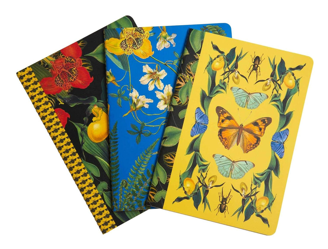 Four notebooks with floral and nature-themed designs on a white background