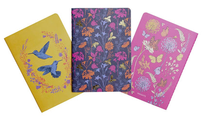Three notebooks with floral and bird designs on a white background