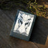 Tarot card box with artwork on a wooden surface