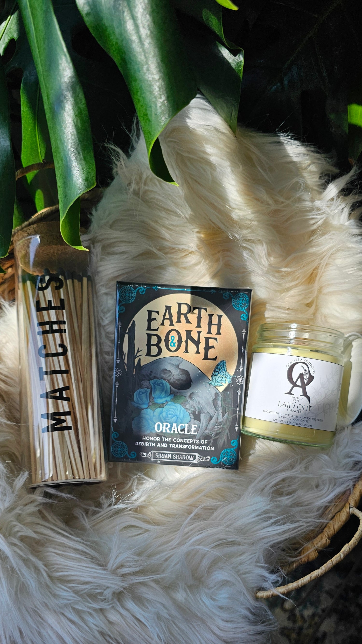 Earth &amp; Bone Oracle deck sitting next to matches and oracles apothecary candle