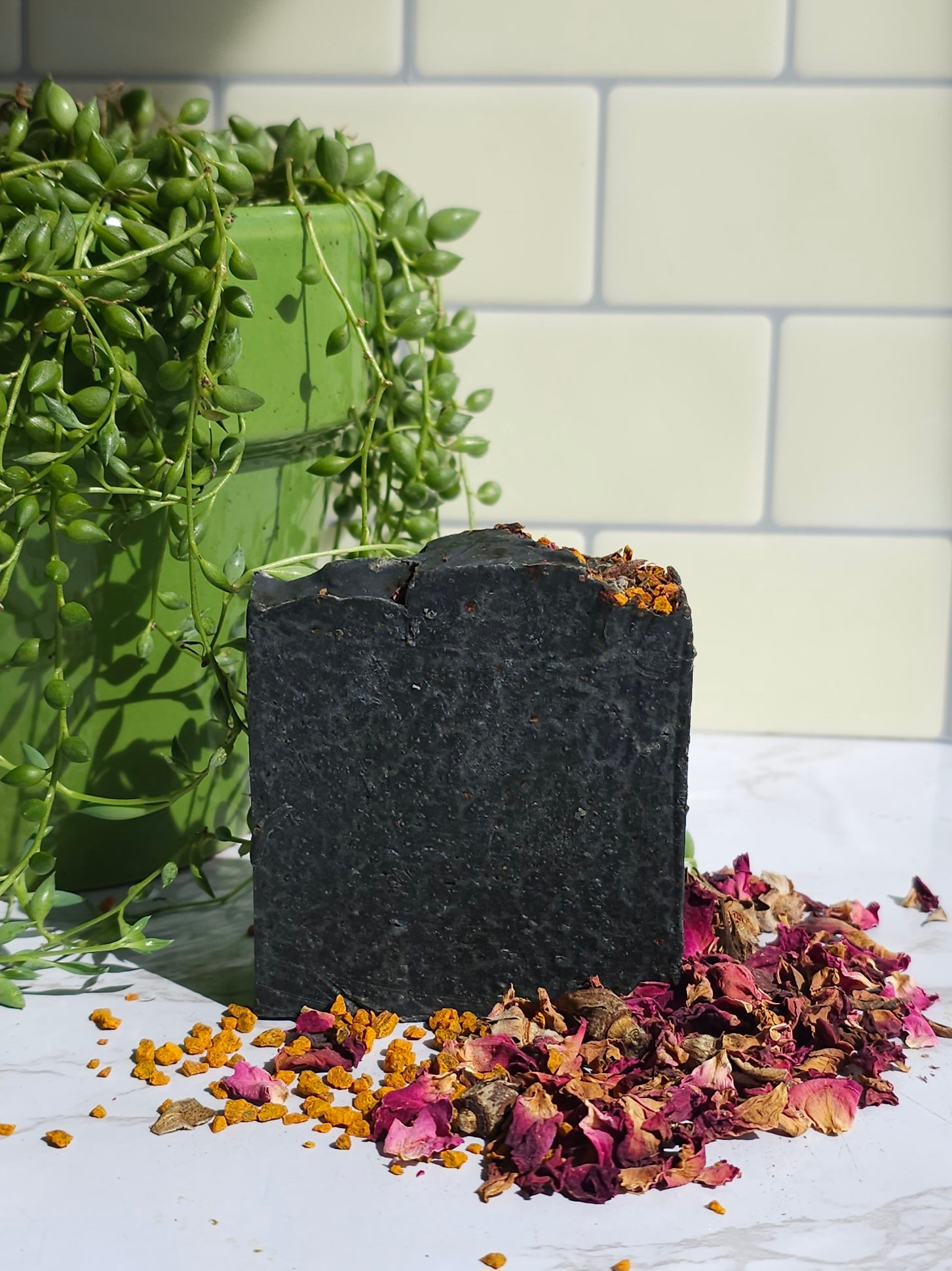 Black Hole Sun Soap sitting in the sun on a white table