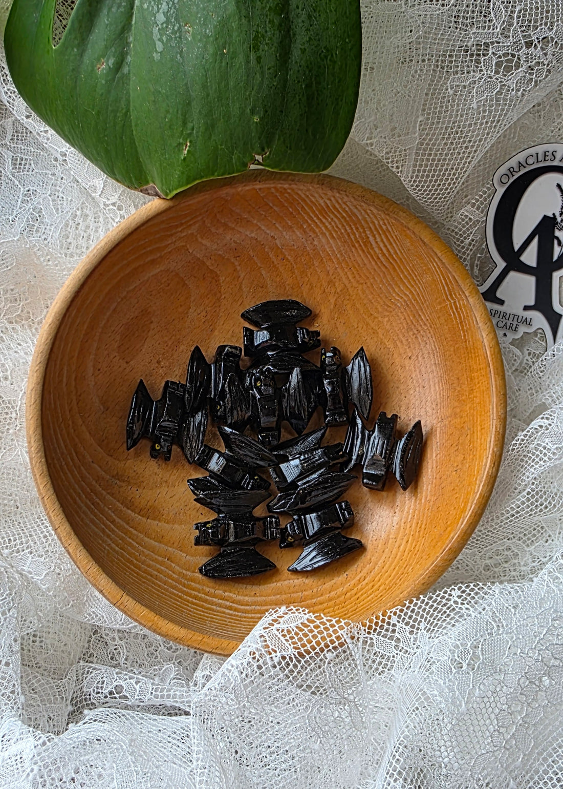 Wooden bowl with black objects on a white lace background