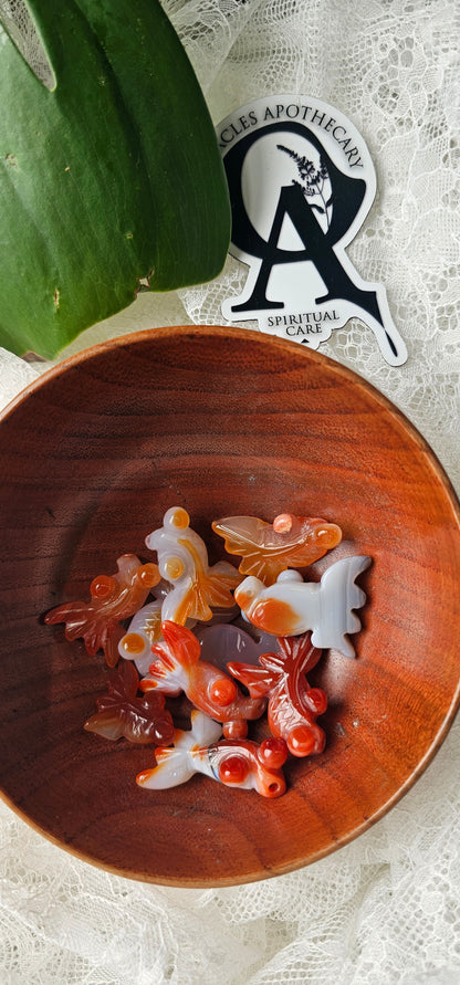 Wooden bowl with decorative items on a textured surface, featuring a logo in the corner.