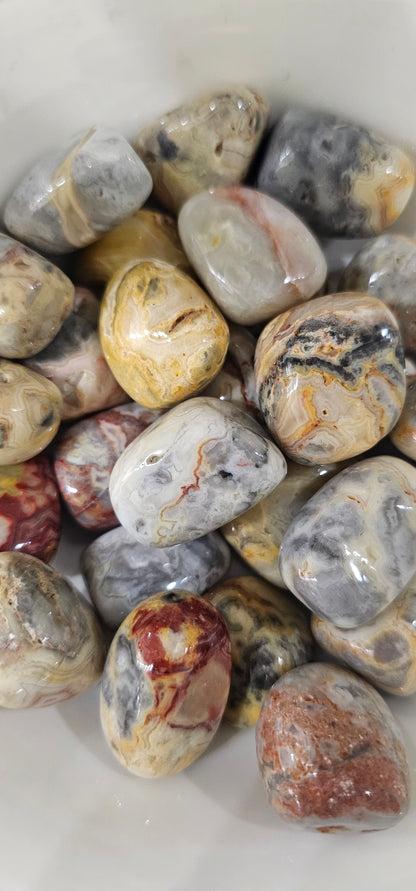 Crazy Lace Agate crystals stones piled up.