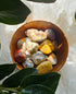 Crazy Lace Agate crystals stones in a wooden bowl