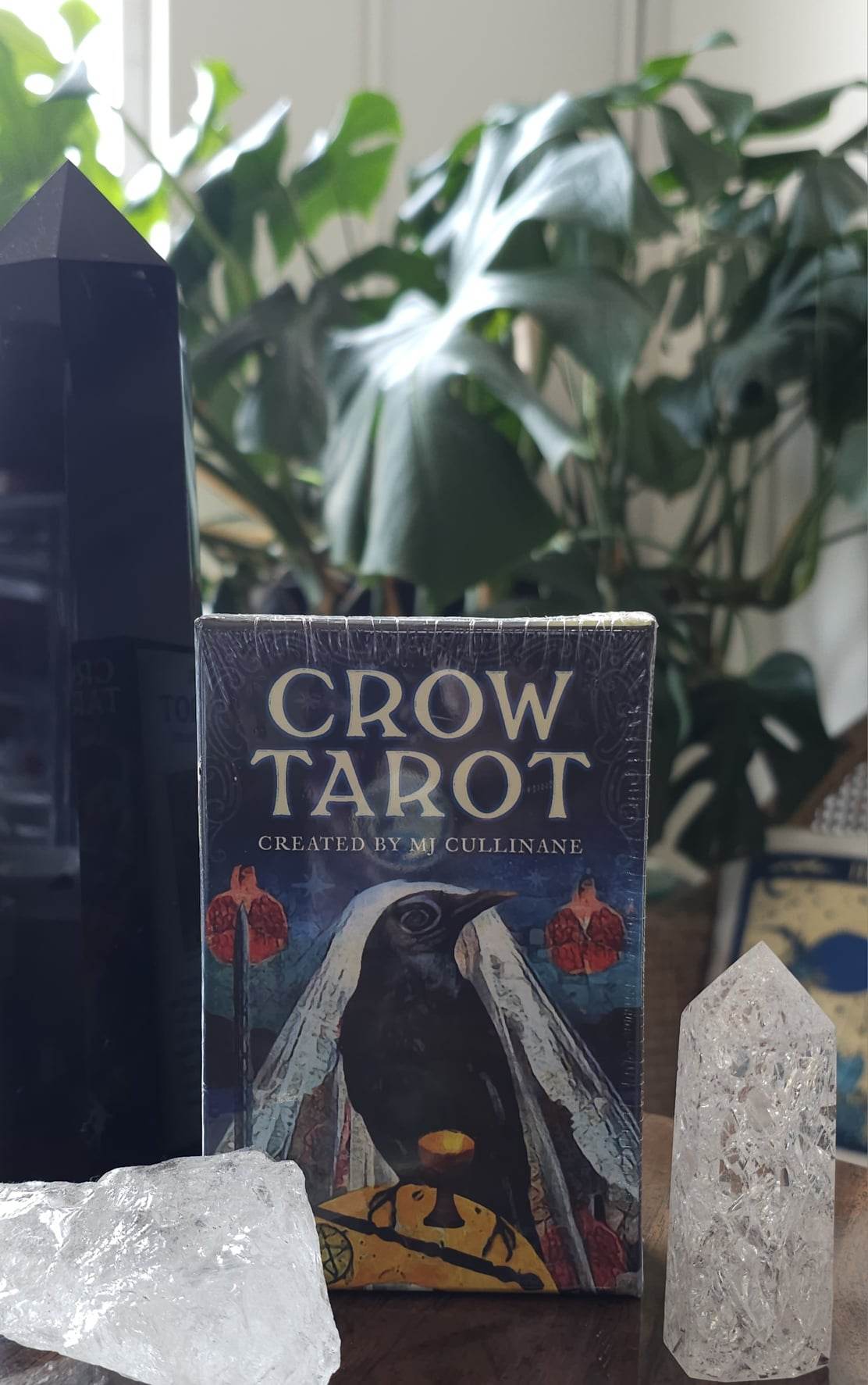 Crow Tarot card deck sitting on a table