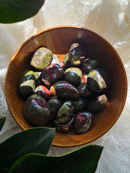 dragons blood crystals stones in a wooden bowl