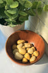 Golden Healer Tumbled stones crystals in a wooden bowl