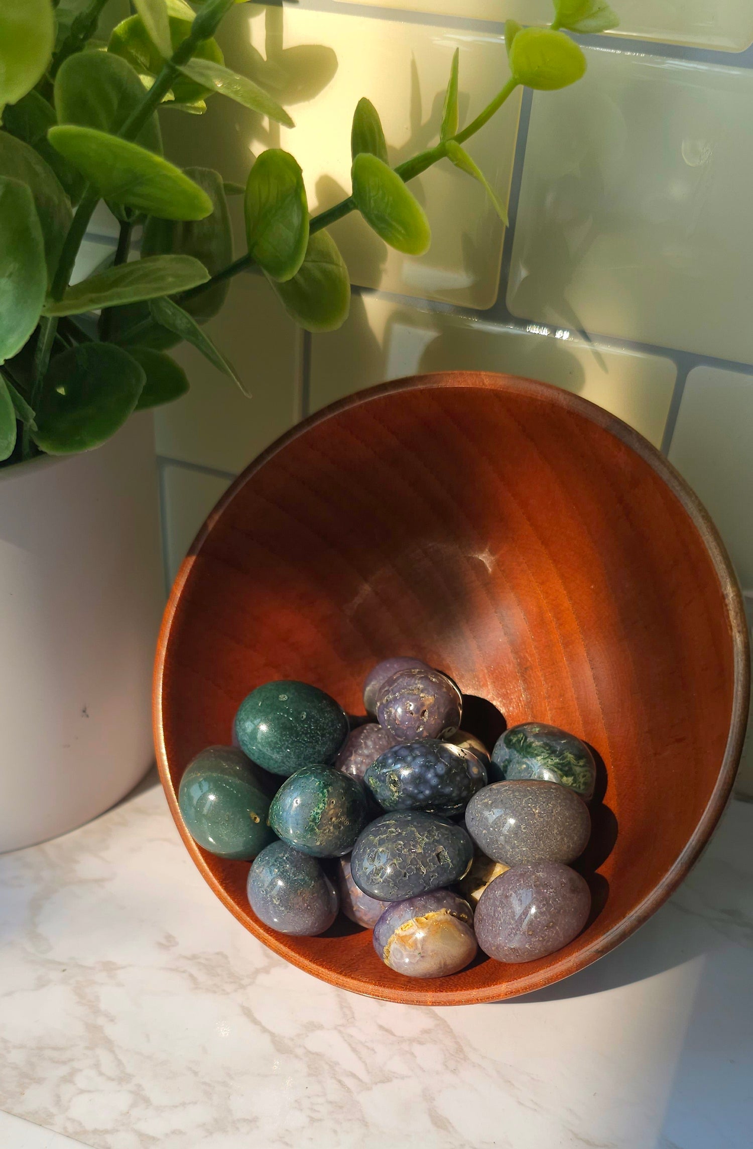 Grape Agate crystals stones in a wooden bowl 