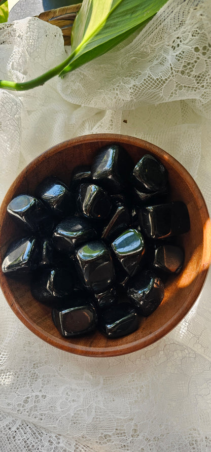 Jet crystals stones piled in a wooden bowl