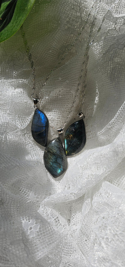 Labradorite necklaces displayed over white lace