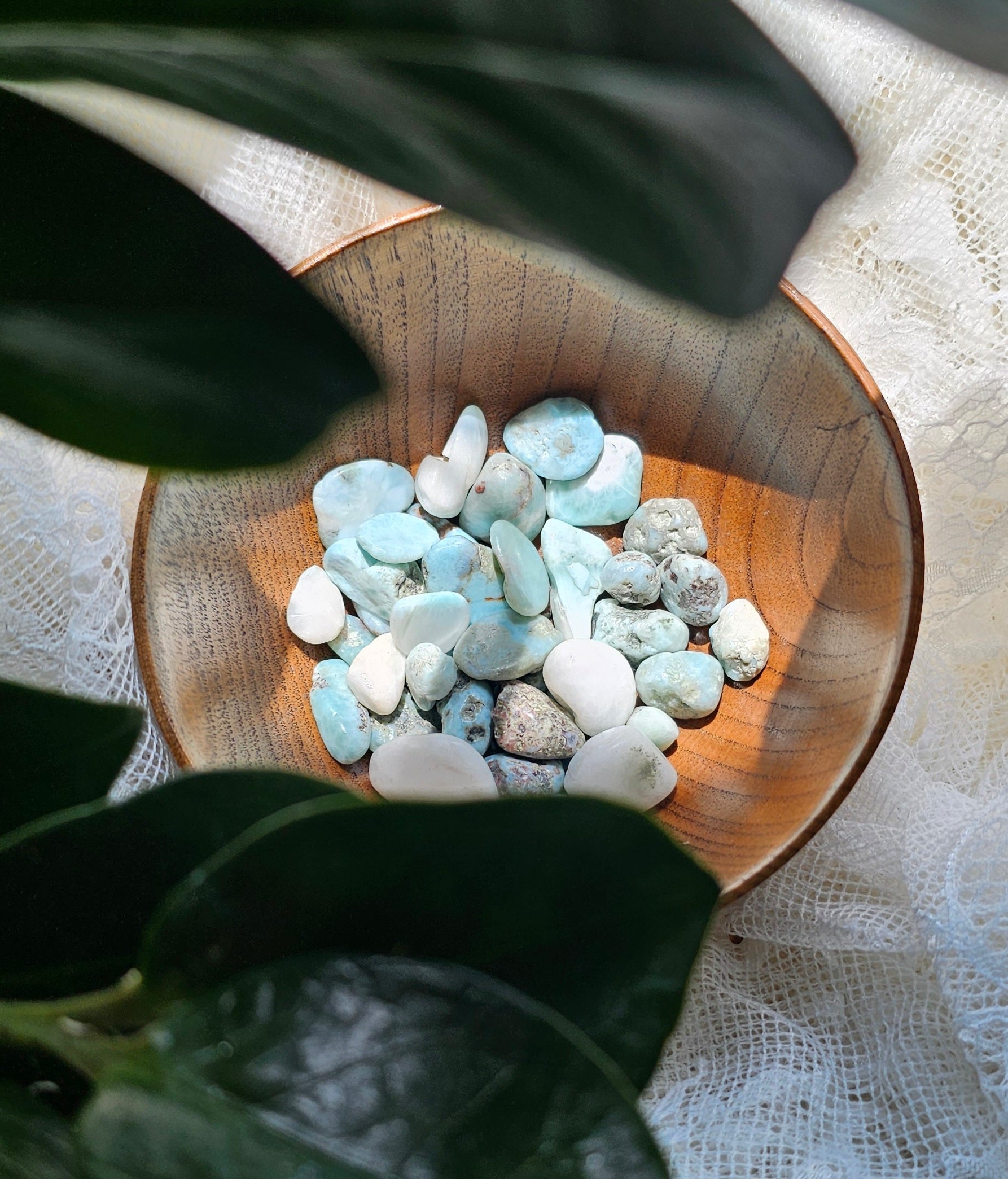 Larimar crystals stones in a wooden bowl