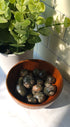 Que Sera crystals stones in a wooden bowl