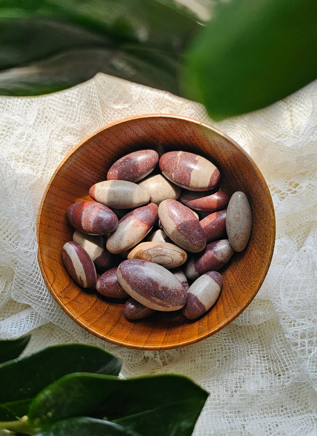 Shiva Lingam crystals stones in a wooden bowl