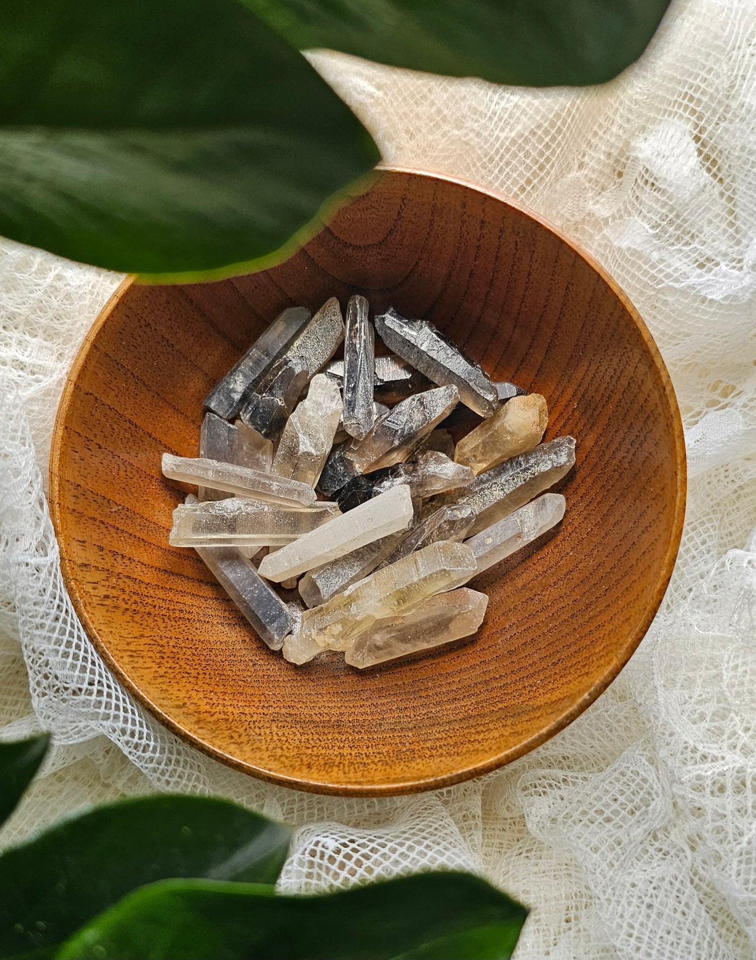 Smokey Quartz Tip crystals stones in a wooden bowl