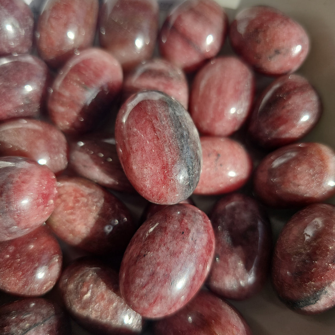Strawberry Quartz crystals stones in a white bowl