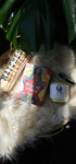 The Medicine Woman Oracle deck next to matches and an oracles apothecary candle