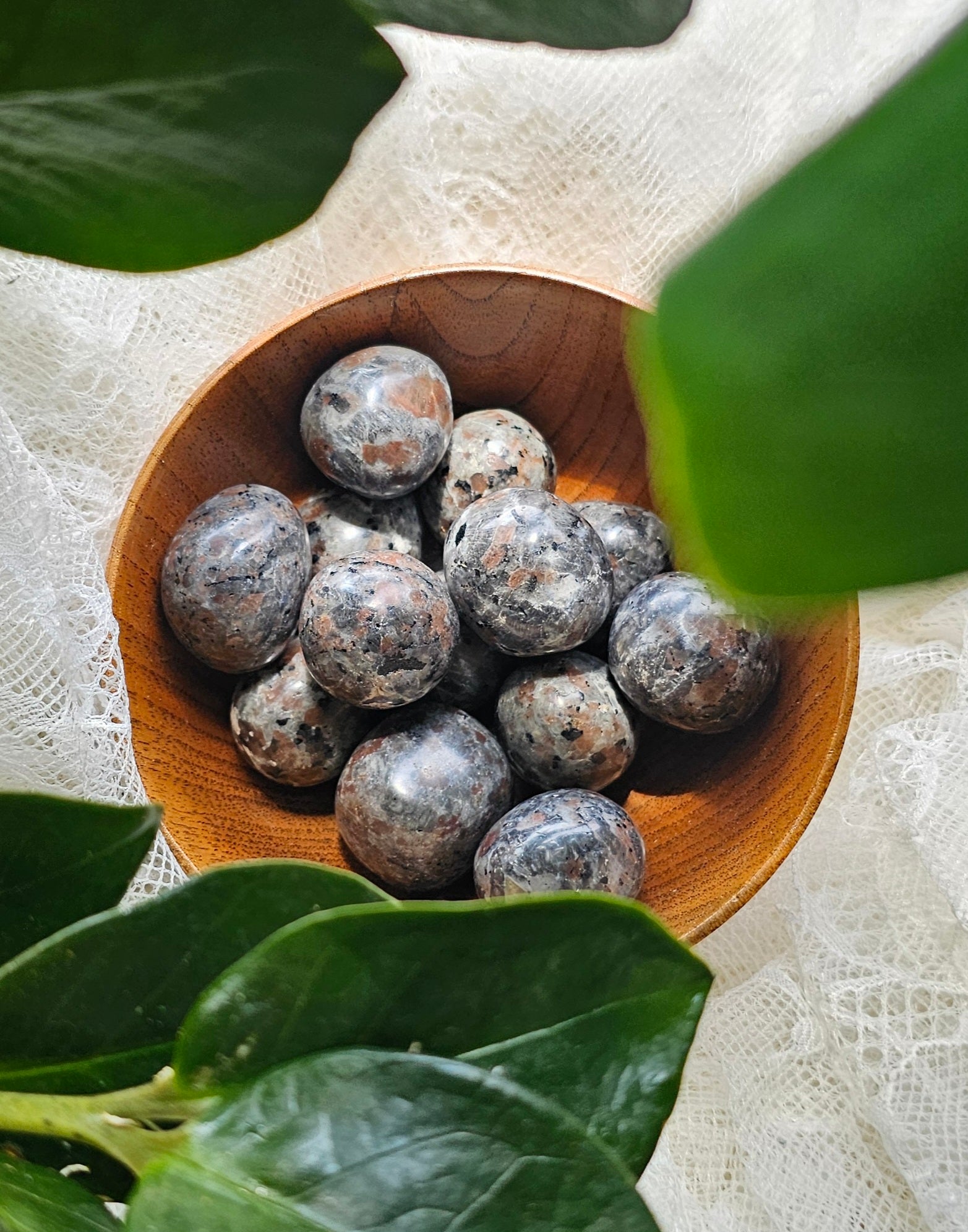 Yooperlite crystals stones piled in a wooden bowl