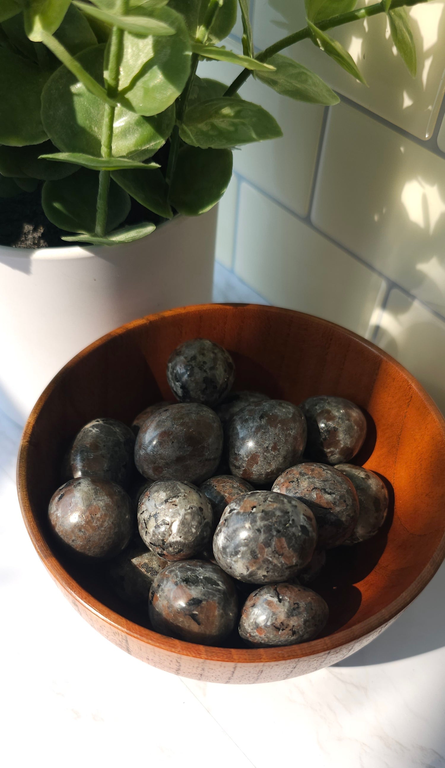 Yooperlite crystals stones piled in a wooden bowl