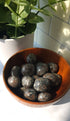 Yooperlite crystals stones piled in a wooden bowl