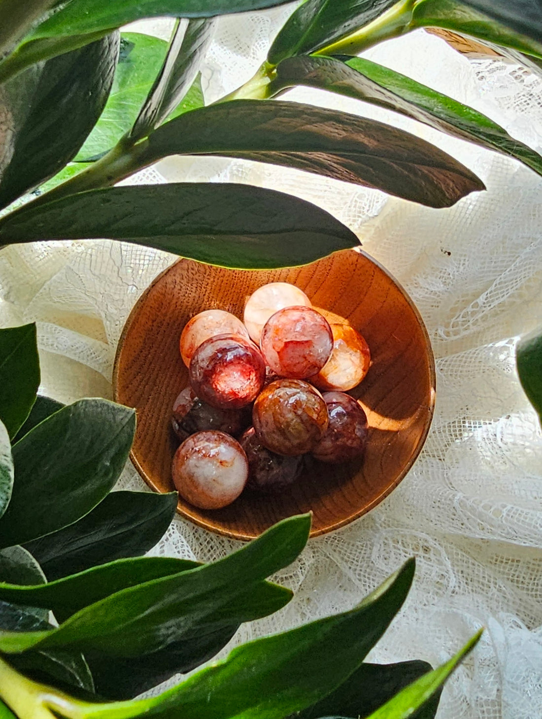 fire quartz spheres in a wooden bowl