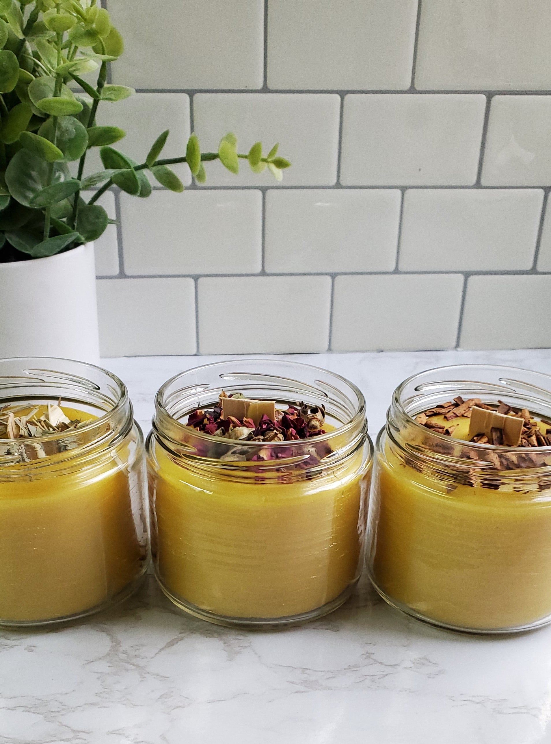 three candle jars with whisper wood wick and herbs