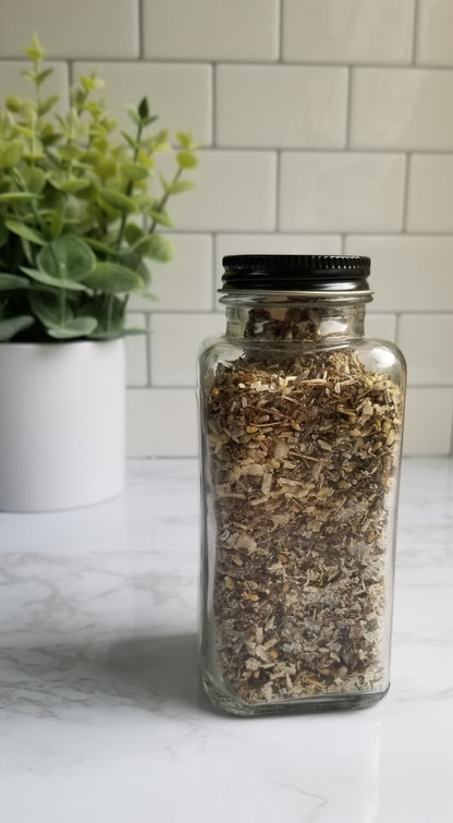 glass jar filled with herbs back view