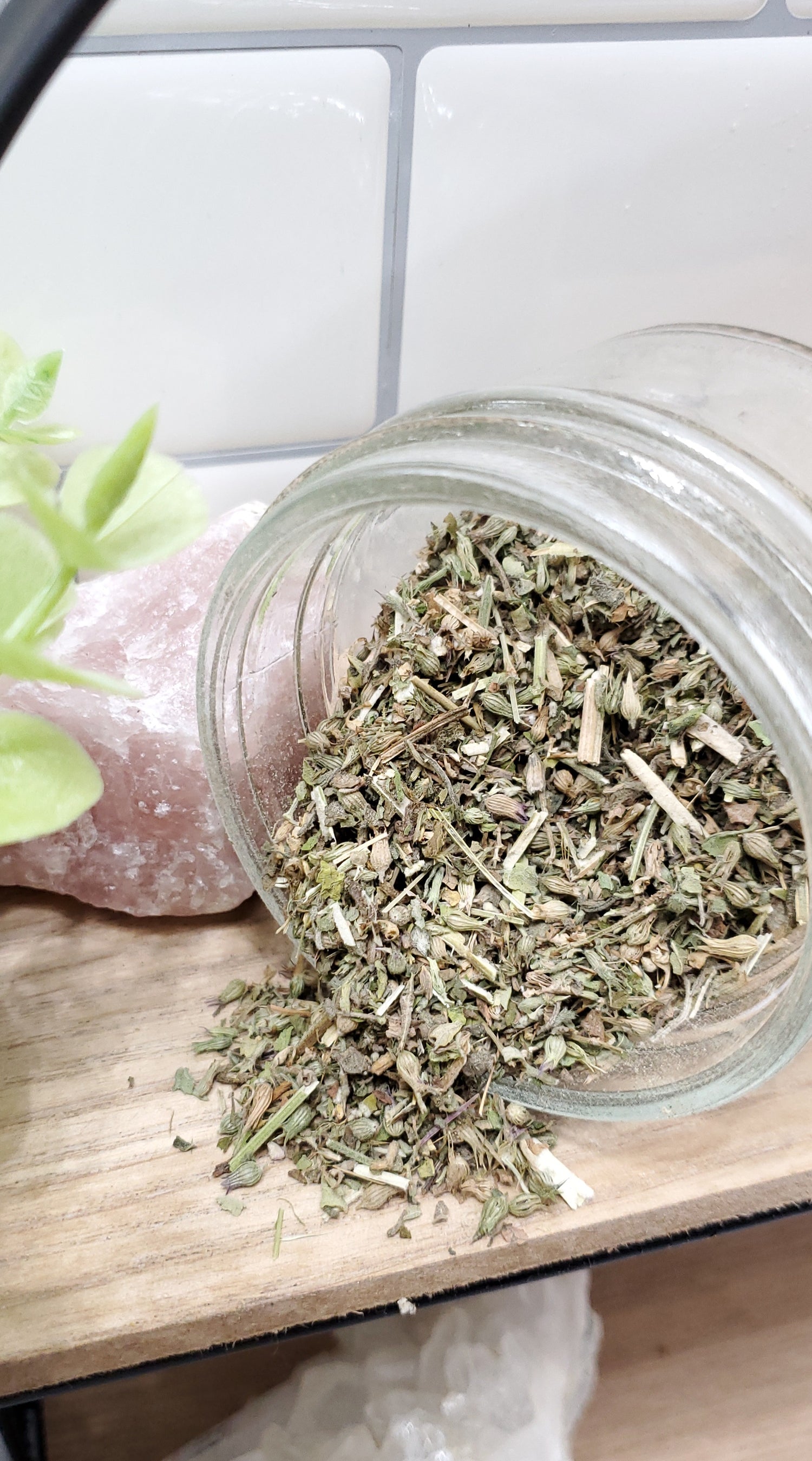 Catnip spilling out of a glass jar