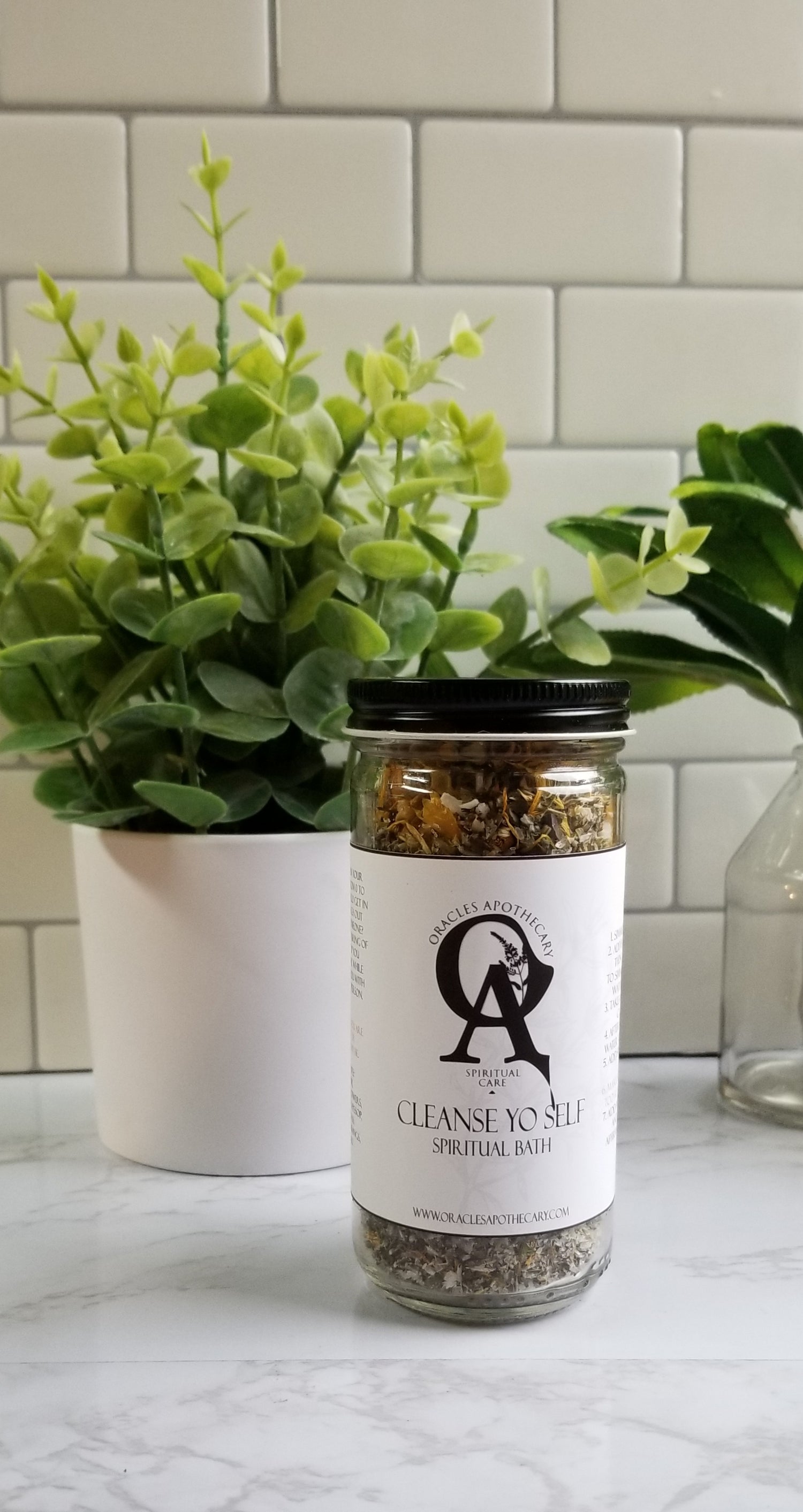 a jar of Cleanse Yo Self Bath herbs sitting on a table